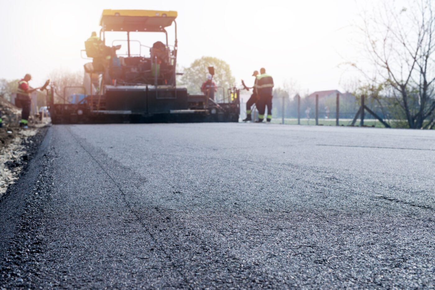 workers-placing-new-coating-asphalt-road